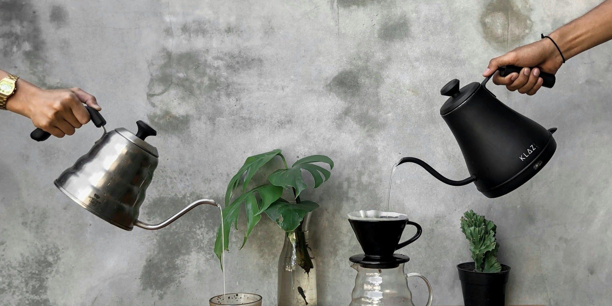 Pour-over coffee setup with gooseneck kettles and a dripper over a glass server