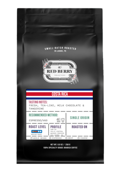 Black coffee bag with a label featuring 'Red Berry' branding and tasting notes for Costa Rica coffee.
