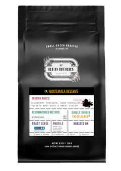 Black coffee bag with 'Red Berry' branding and Guatemala Reserve coffee details.